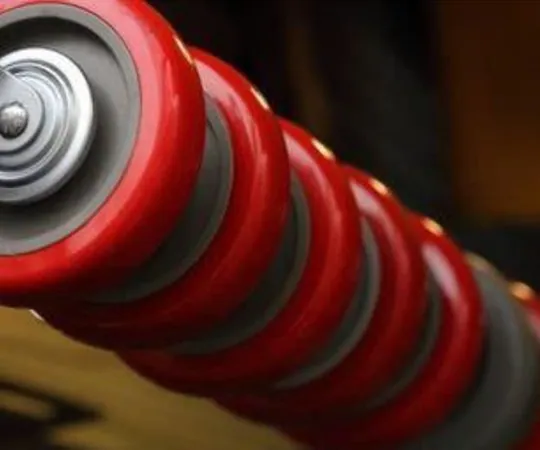 Row of red industrial castor wheels.